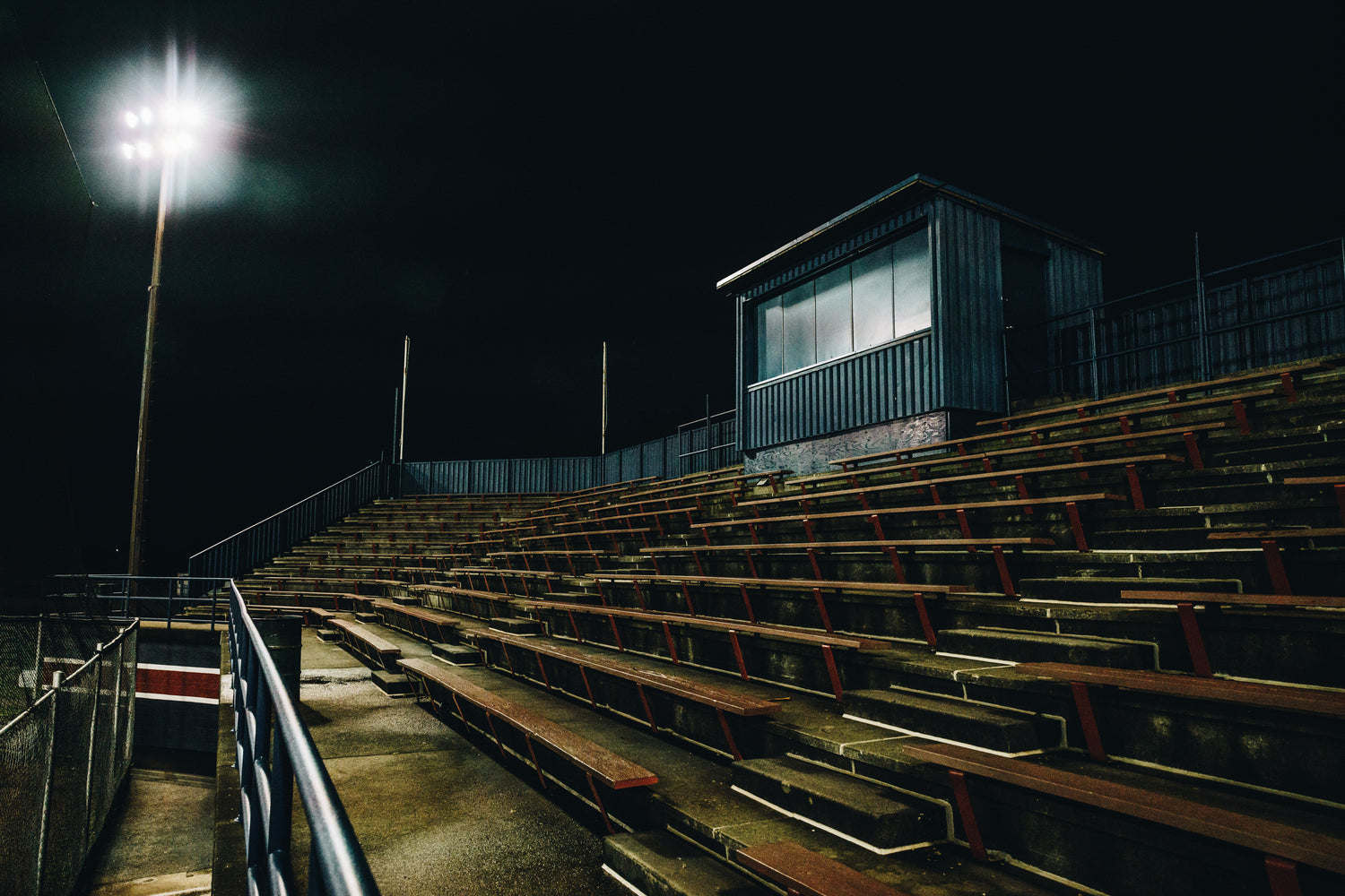 empty sports field stands at night