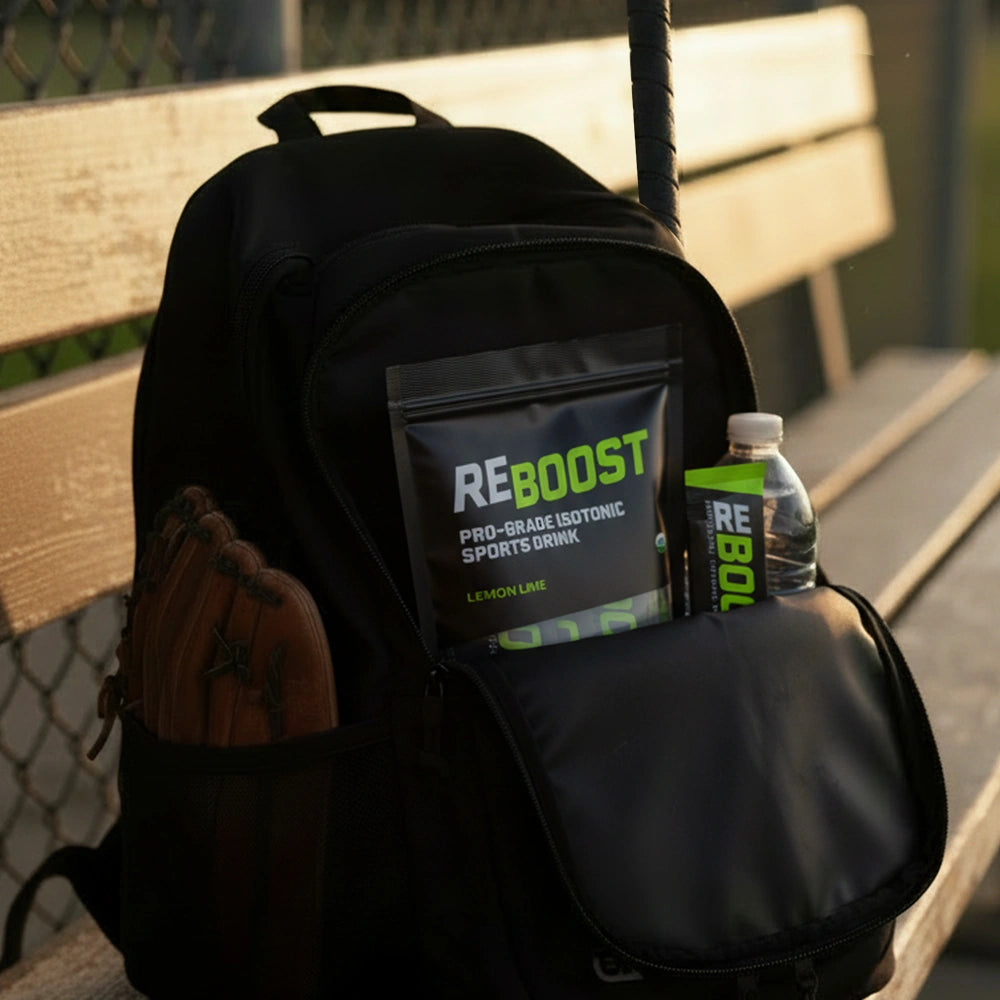 Black backpack with REBOOST sports drink and water bottle on a bench