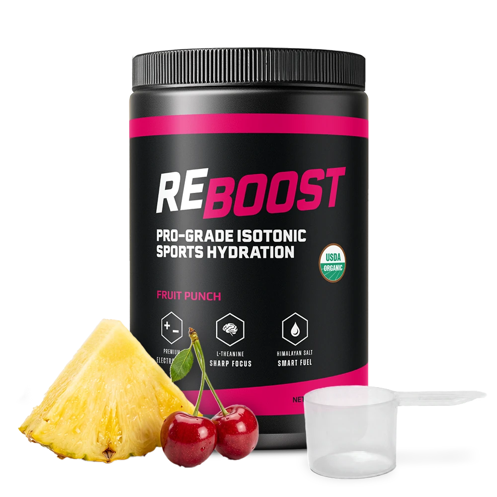A black tub of REBOOST Pro-Grade Isotonic Sports Hydration in Fruit Punch flavor, shown on a white background with a pineapple slice, two red cherries, and a clear plastic scoop.