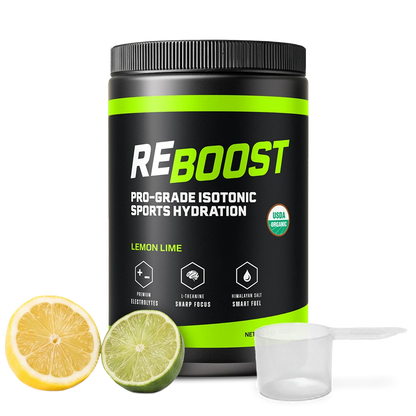 A black tub of REBOOST Pro-Grade Isotonic Sports Hydration in Lemon Lime flavor, shown on a white background with a lemon half, lime half, and a clear scoop.