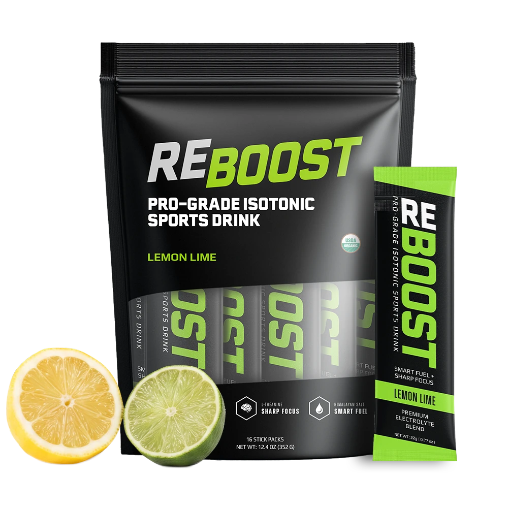 A stand-up pouch of REBOOST Pro-Grade Isotonic Sports Drink in Lemon Lime flavor, shown with a single stick pack and lemon and lime slices on a clean white background.